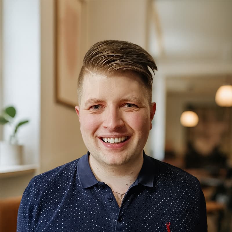 Ásgeir Hólm, founder of Moonstreak, smiling in a Reykjavík café